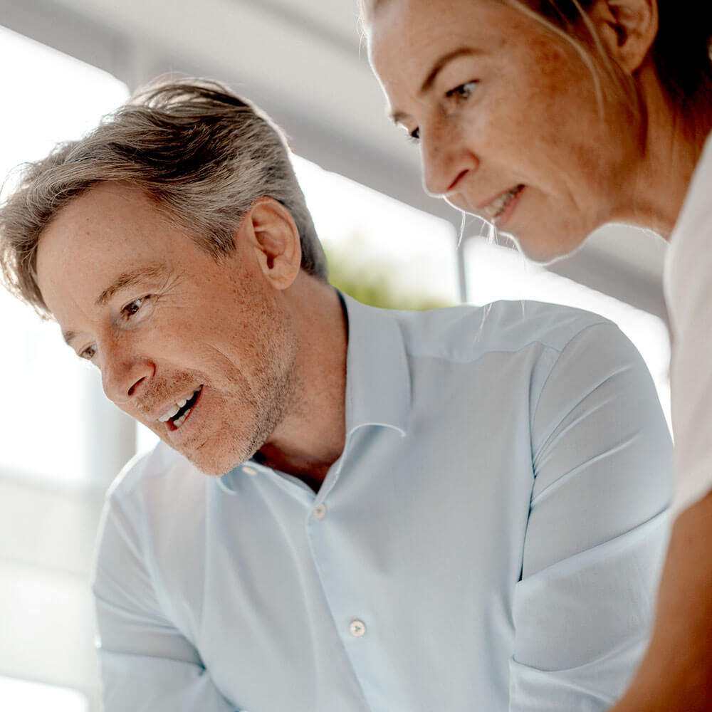 Die Graphik zeigt einen Herren und eine Frau in Businesskleidung mit Link zu dem Bereich Umweltförderung für Gemeinden